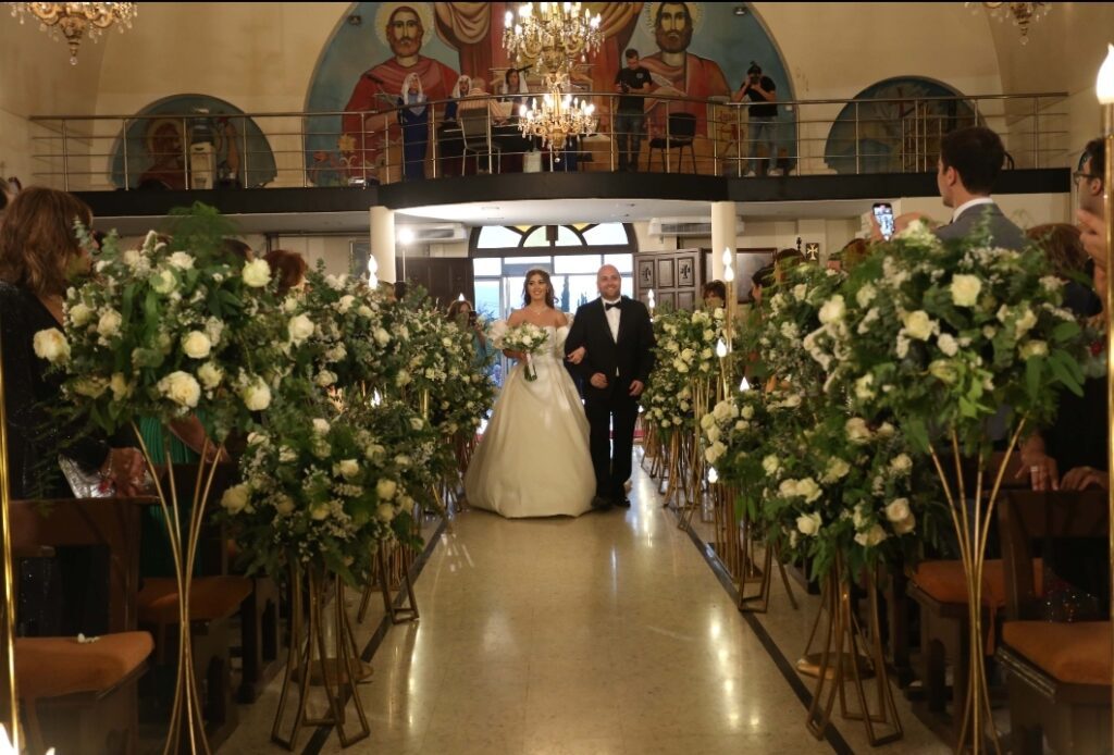 a man and woman walking down a aisle