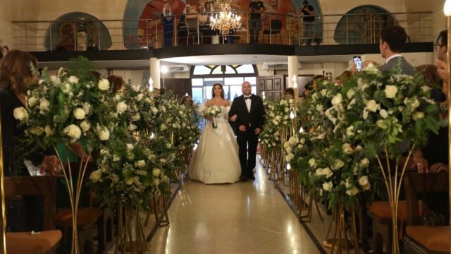 a man and woman walking down a aisle