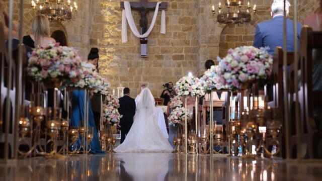 a bride and groom walking down a aisle