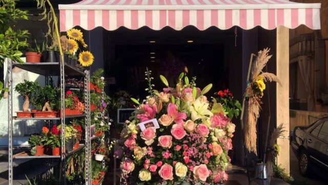 a flower shop with a large bucket of flowers