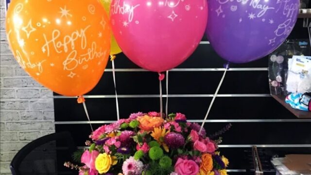 a bunch of flowers and balloons