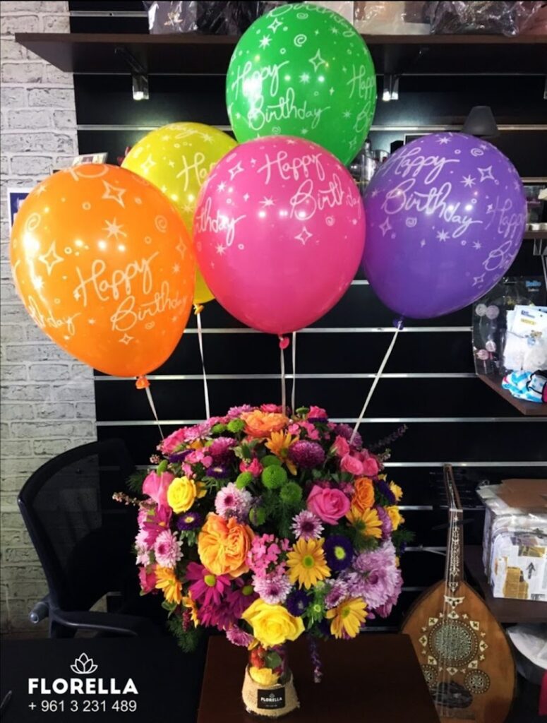 a bunch of flowers and balloons