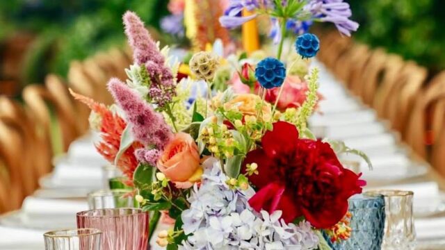 a table with flowers and glasses