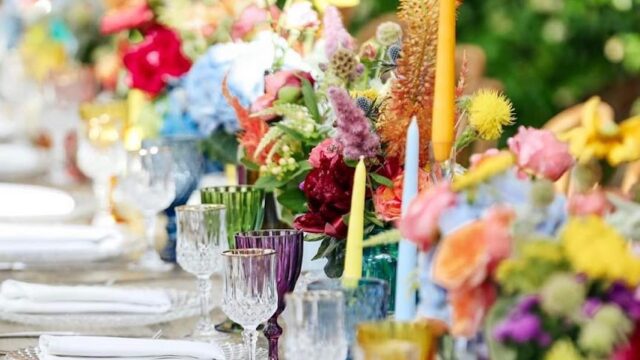 a table with flowers and glasses