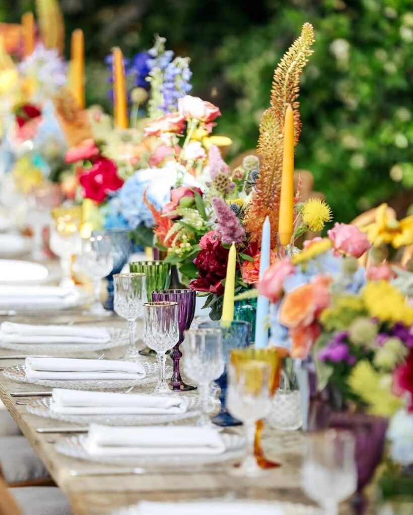 a table with flowers and glasses