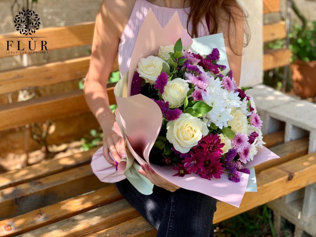 a woman holding a bouquet of flowers