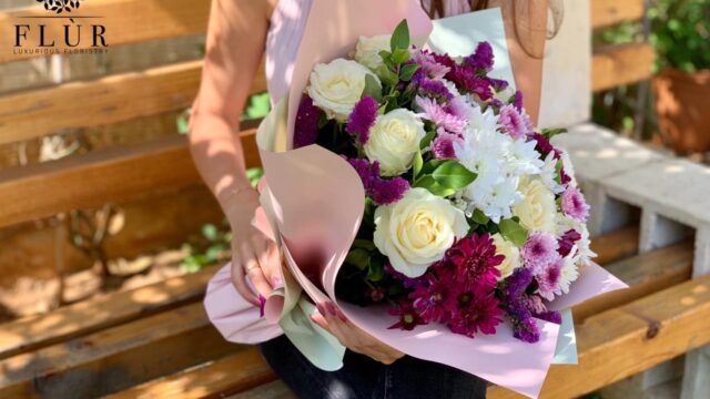 a woman holding a bouquet of flowers