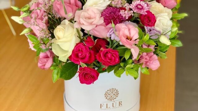 a bouquet of flowers in a white box