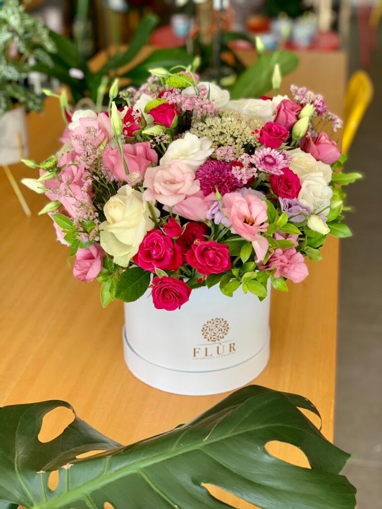 a bouquet of flowers in a white box