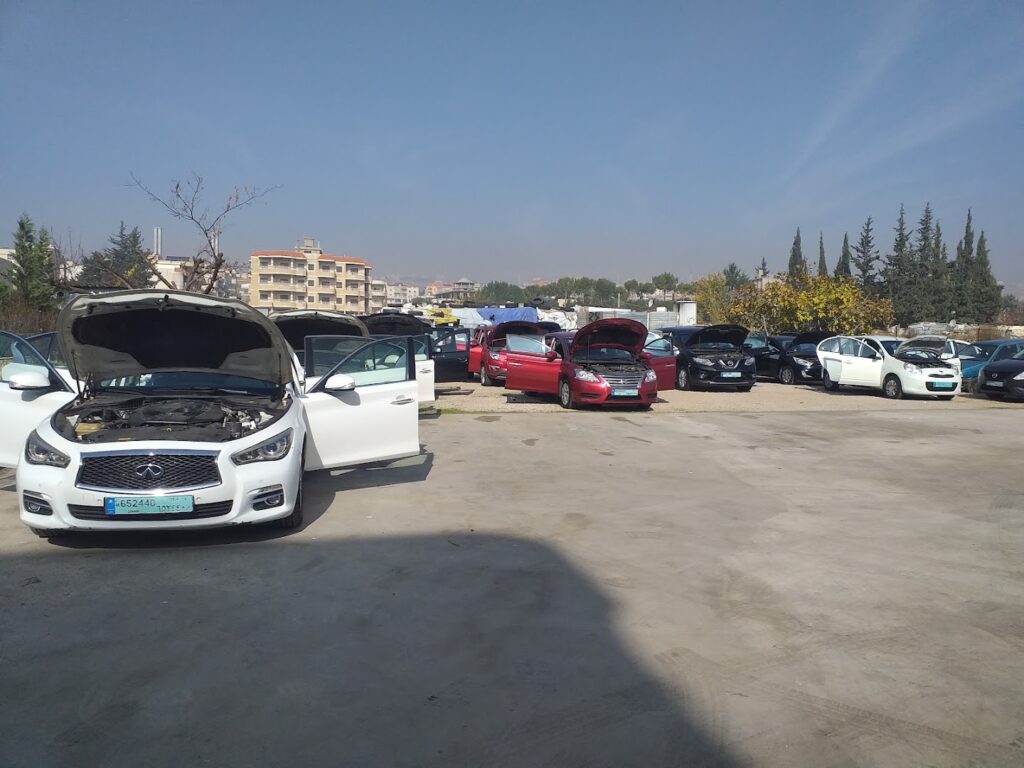 a group of cars with hoods in a parking lot
