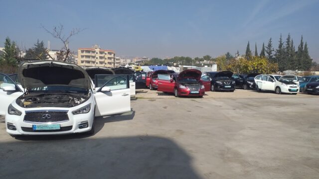 a group of cars with hoods in a parking lot