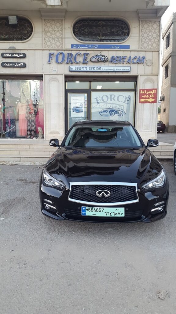 a black car parked in front of a building