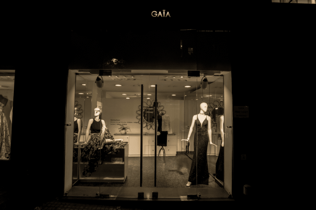 a store front with mannequins in a dress