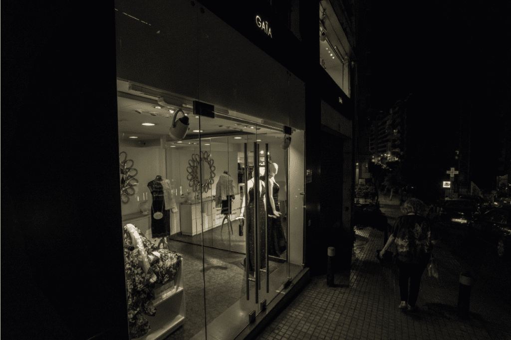 a storefront with mannequins and mannequins in front of a building