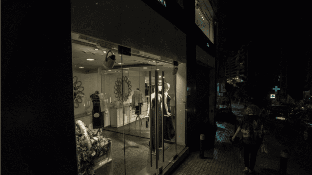 a storefront with mannequins and mannequins in front of a building