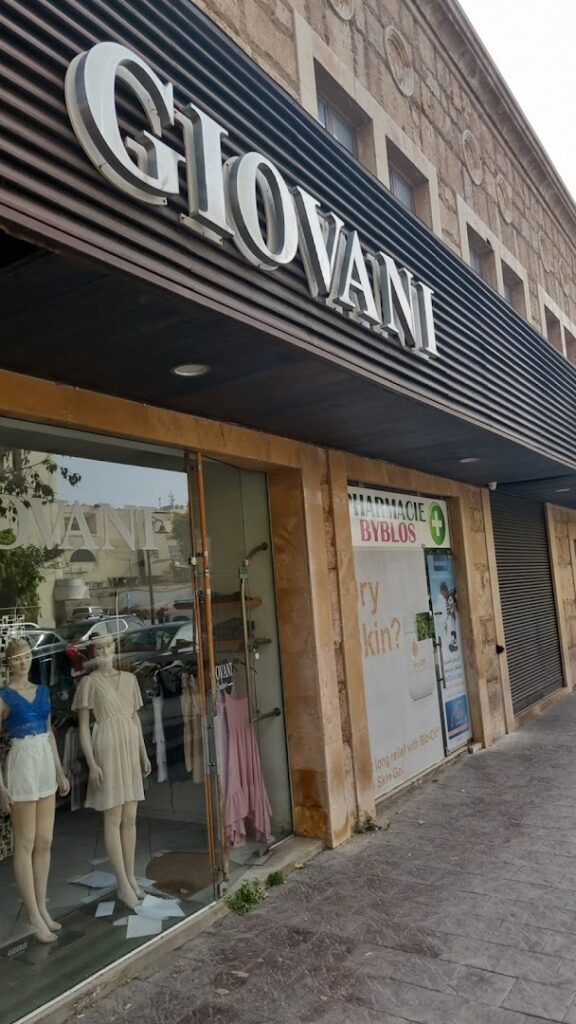 a store front with mannequins in front of it