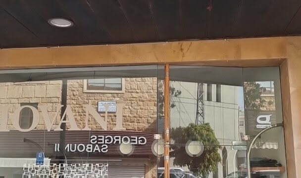 a store front with mannequins in a window