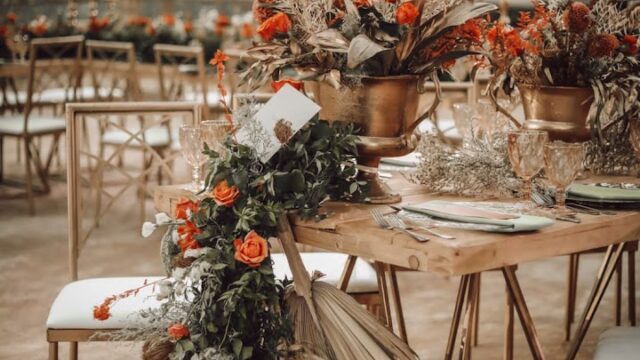 a table set up with flowers and chairs