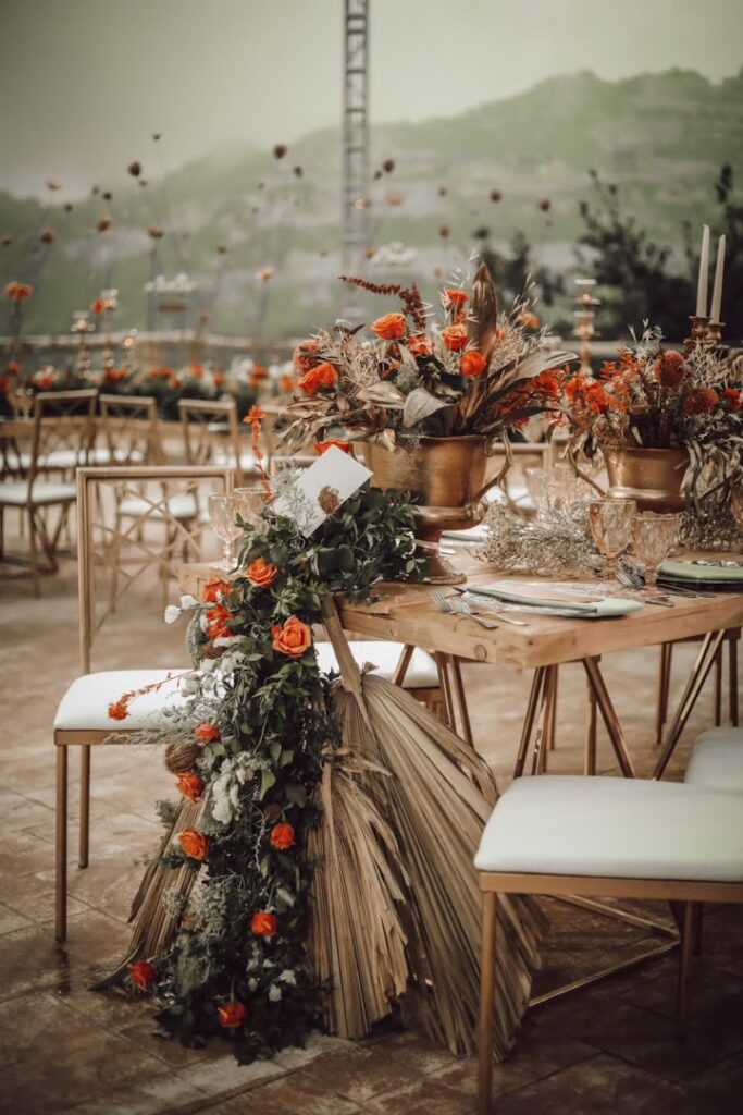 a table set up with flowers and chairs