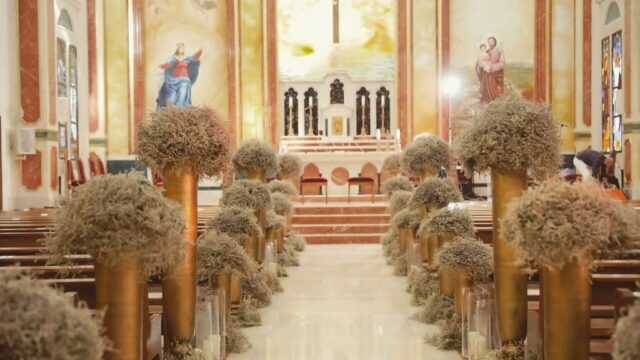 a church with flowers and chairs