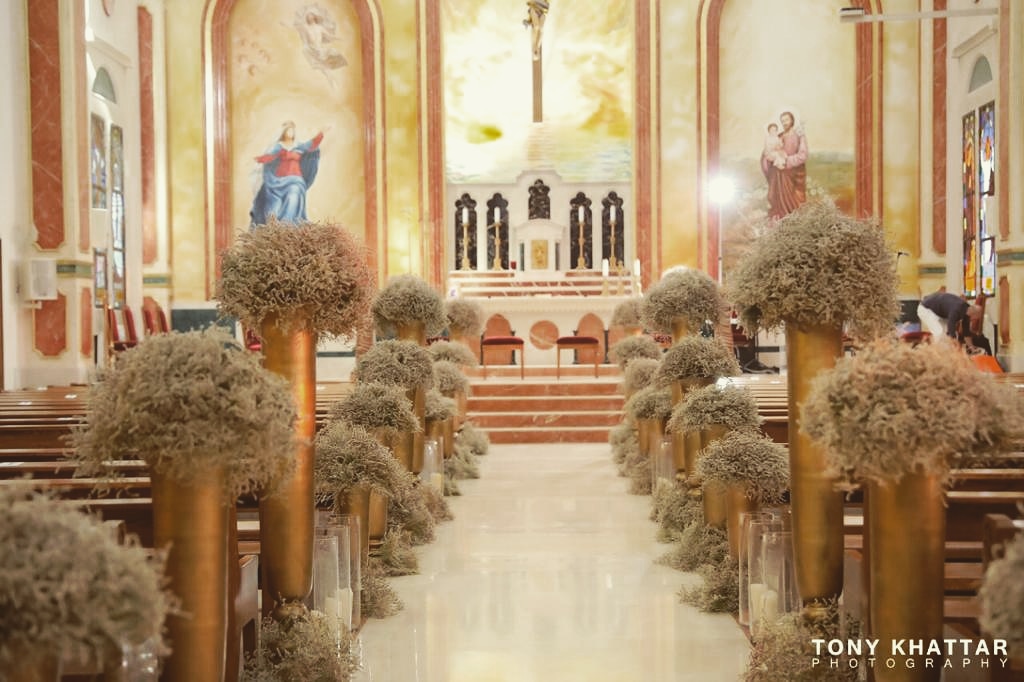 a church with flowers and chairs