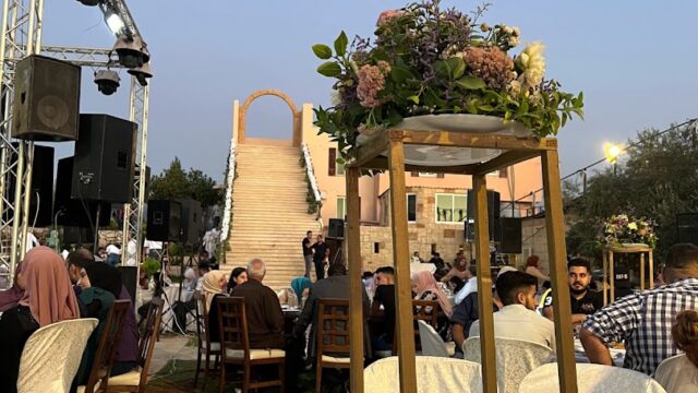 a group of people sitting around tables and chairs