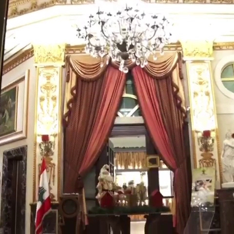 a chandelier in a room with a chandelier and a statue