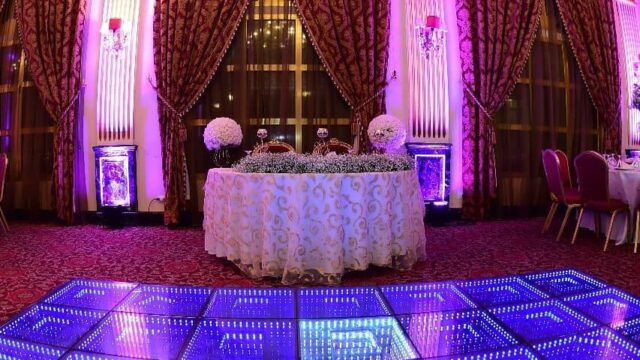 a room with a table and purple lights