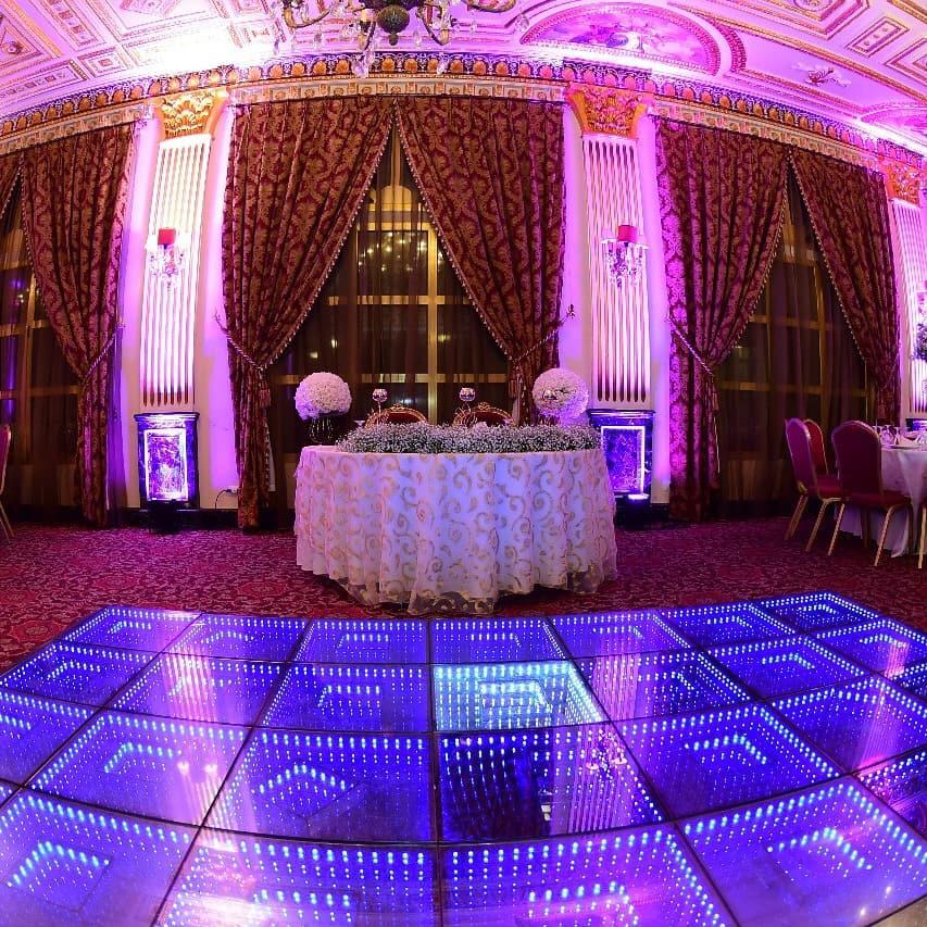 a room with a table and purple lights