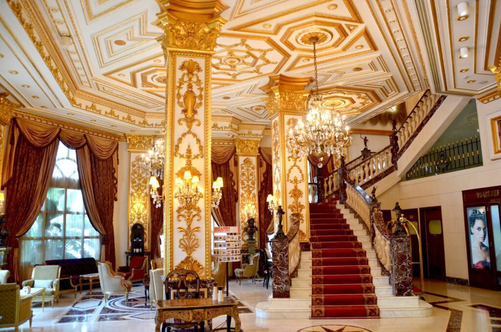 a large ornate building with chandeliers and stairs