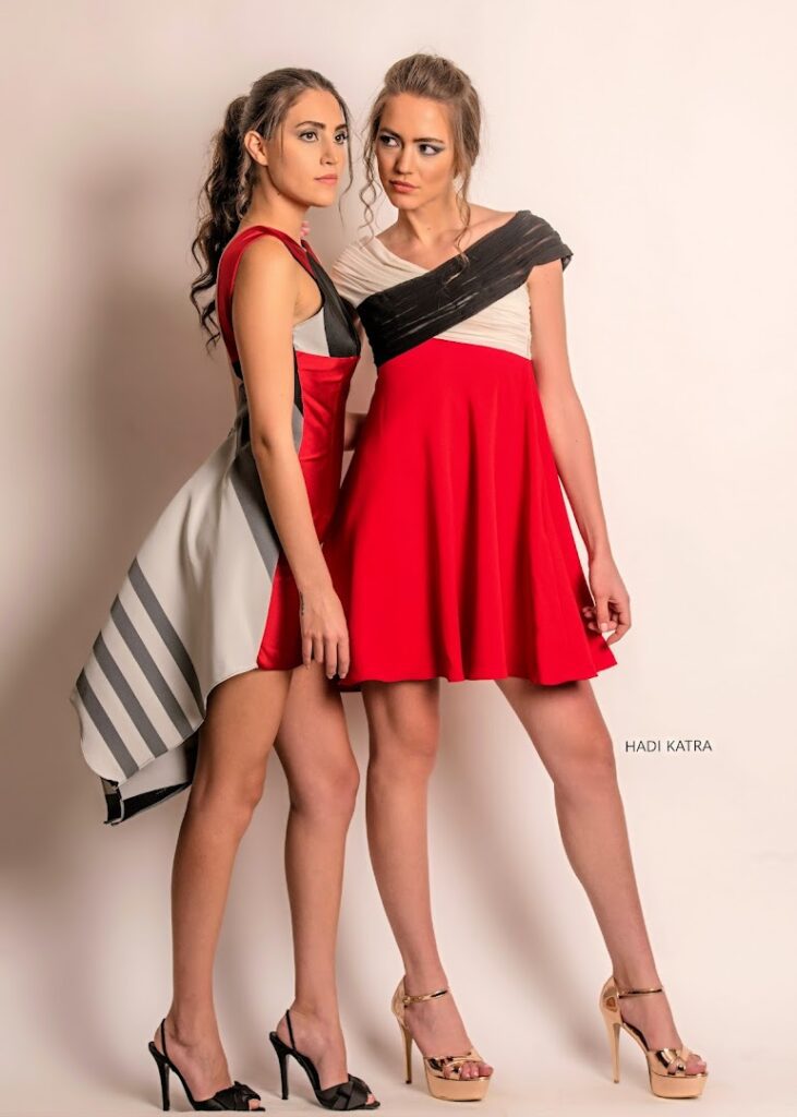 two women in dresses posing for a picture