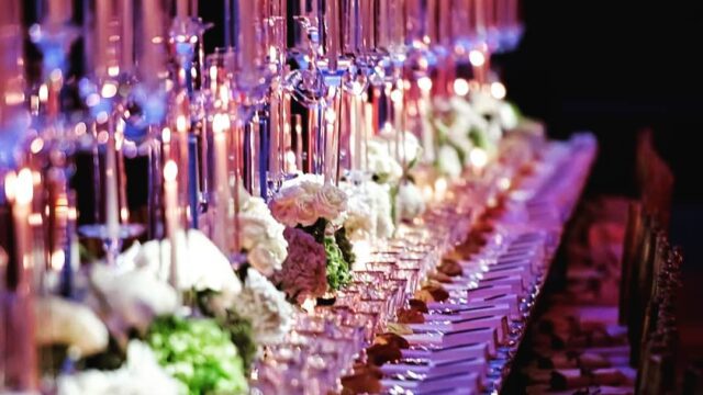 a long table with many glasses and candles