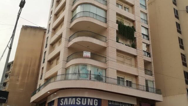 a building with cars parked in front of it