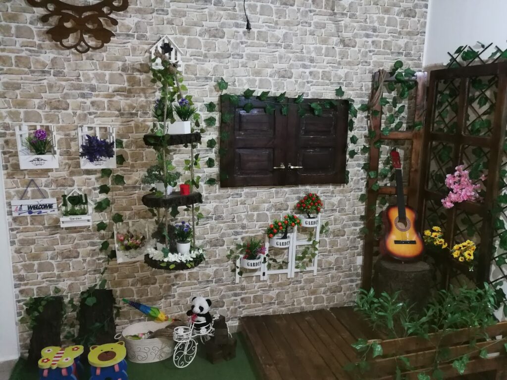 a room with a guitar and plants