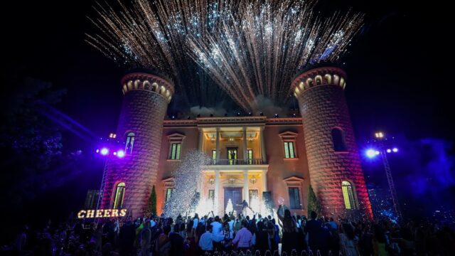 fireworks in the sky above a building