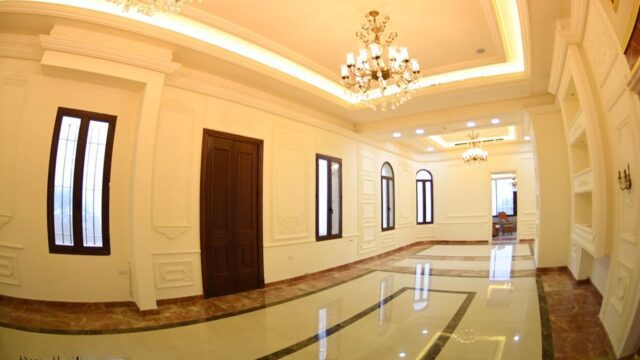 a room with chandeliers and marble floor