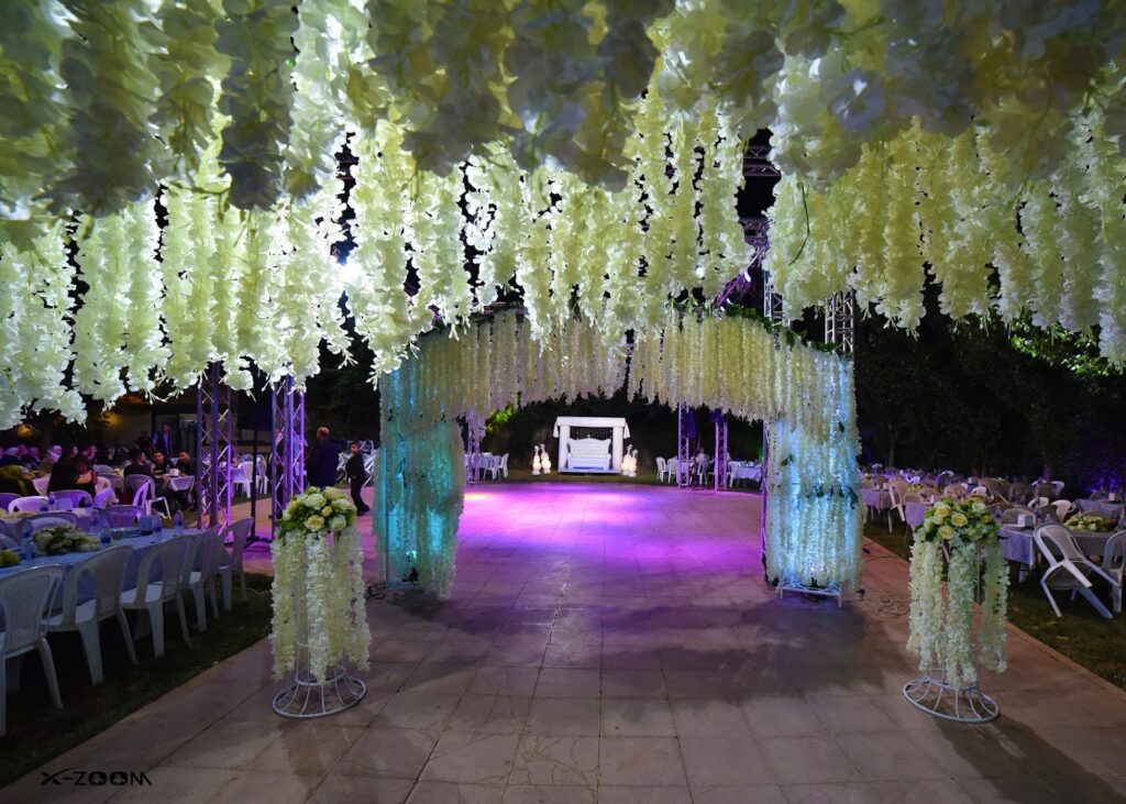 a white and yellow flower covered walkway