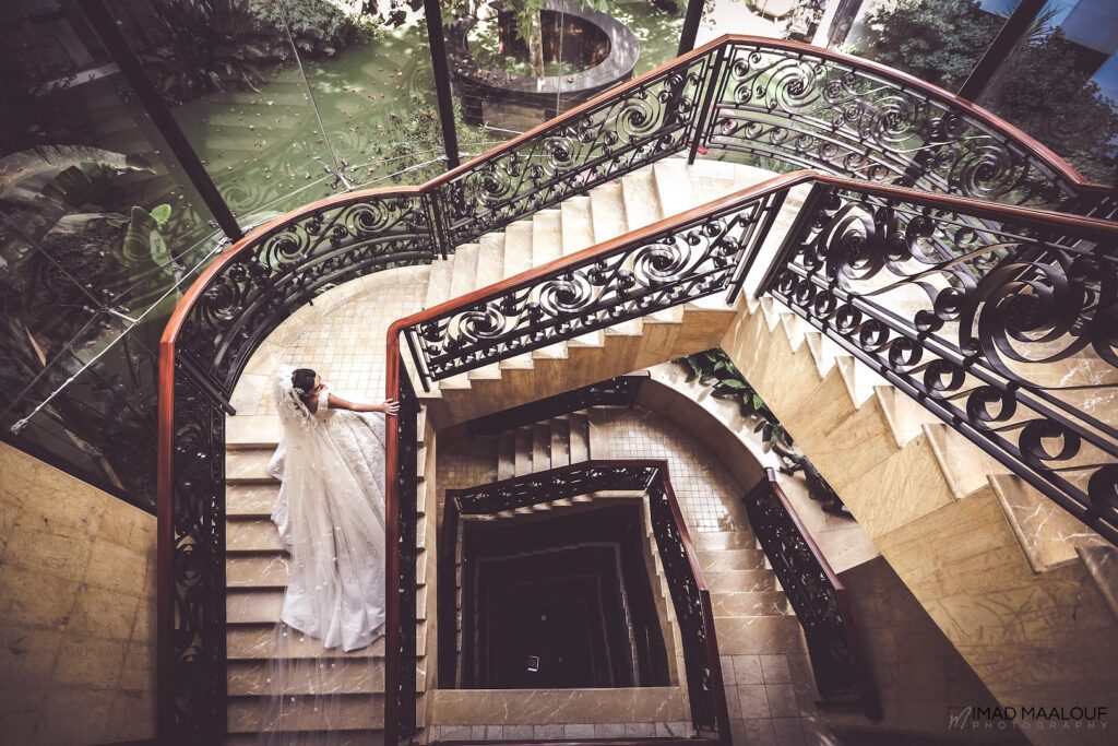 a woman in a wedding dress on a staircase