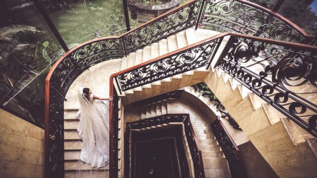 a woman in a wedding dress on a staircase