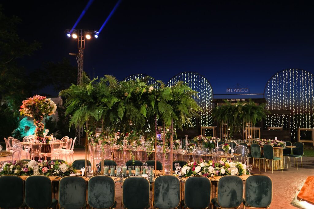 a set up table with chairs and tables with candles and flowers