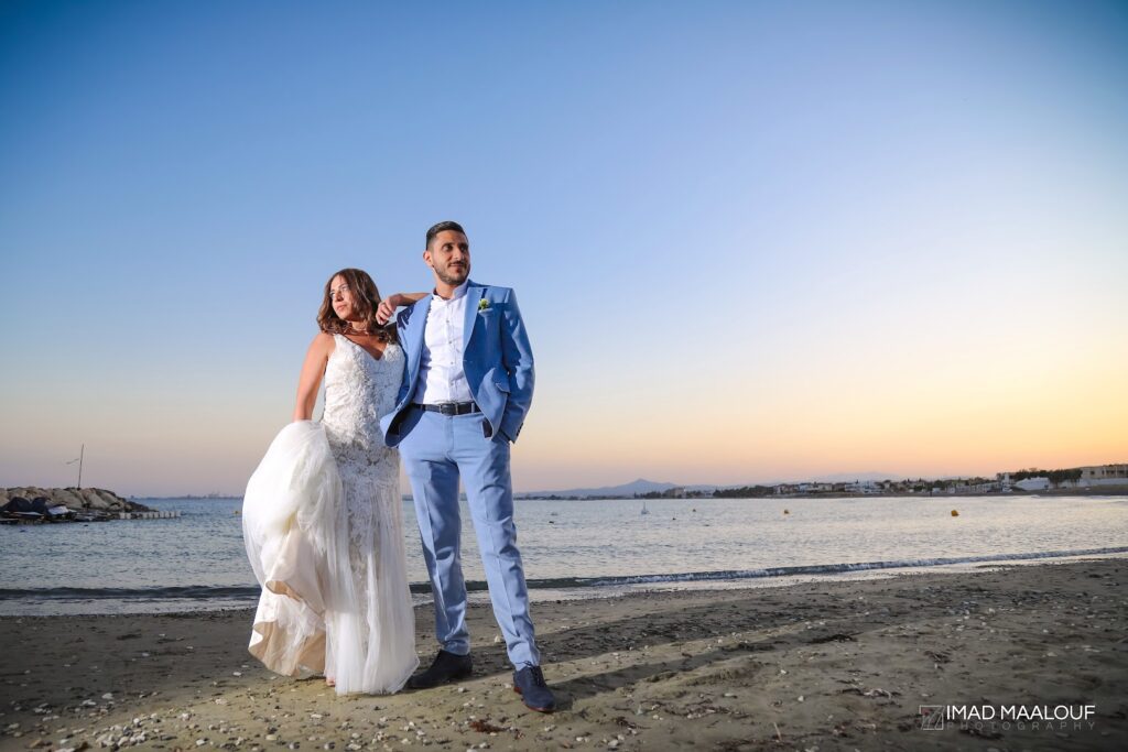 a man and woman posing for a picture on a beach