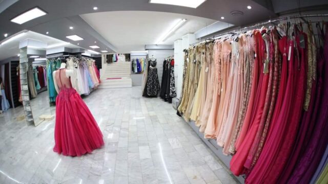 a room with many dresses on swingers