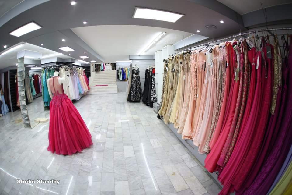 a room with many dresses on swingers