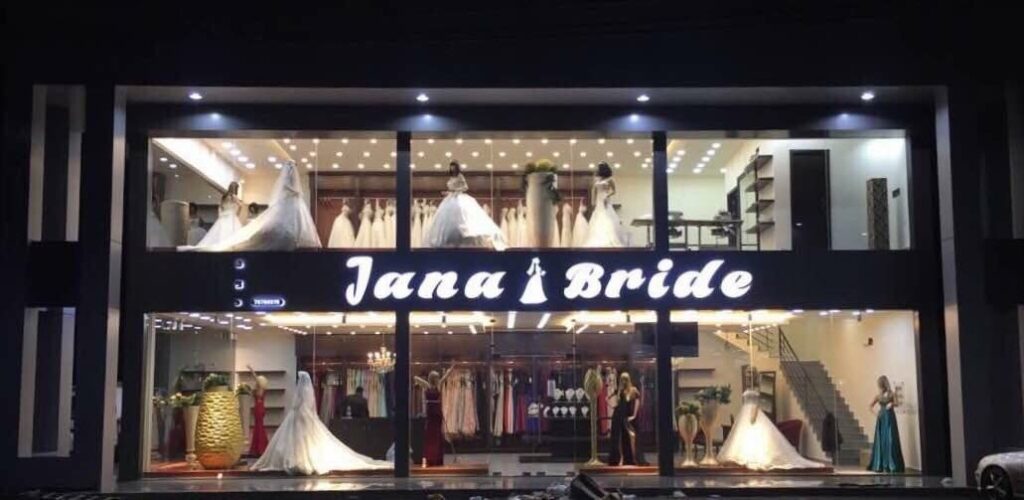 a store front with mannequins in wedding dresses
