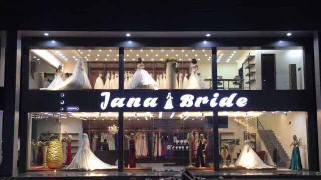 a store front with mannequins in wedding dresses