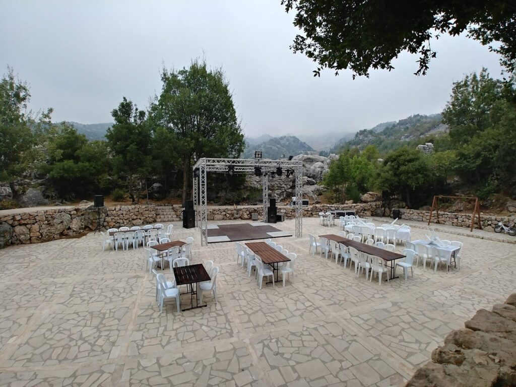 a outdoor stage with tables and chairs