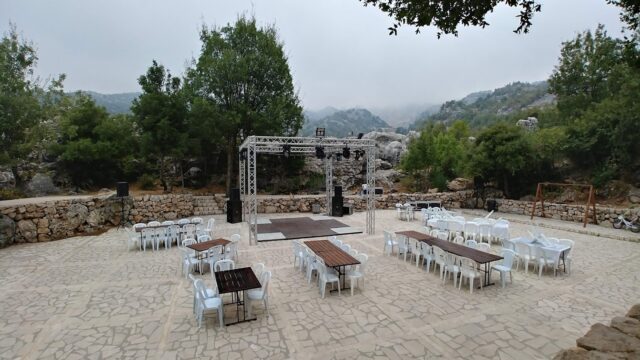 a outdoor stage with tables and chairs