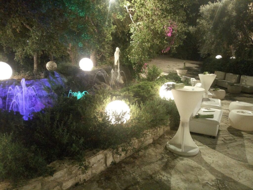 a fountain with lights and tables