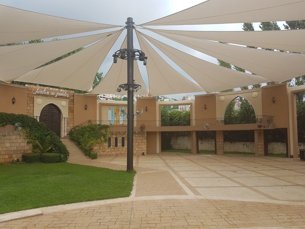 a large white tent in a courtyard