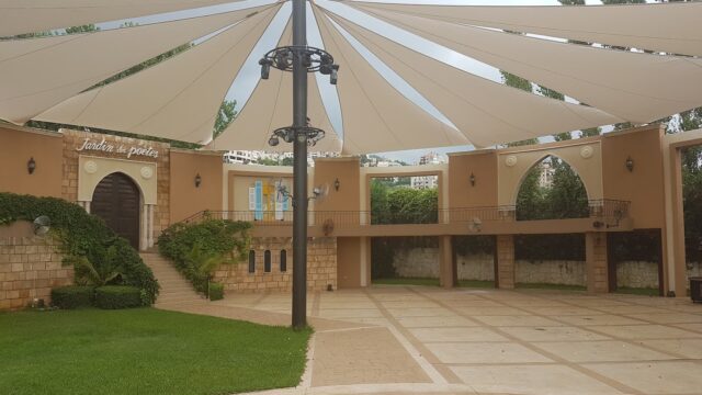 a large white tent in a courtyard